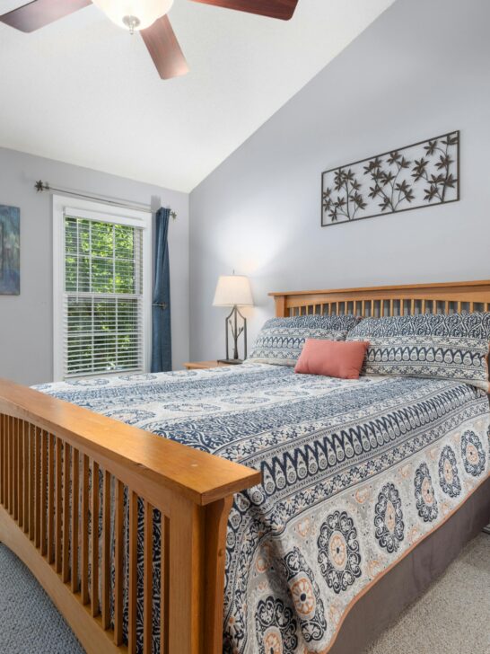 Bright guest bedroom with large bed, natural light, and clean layout for comfortable overnight stays