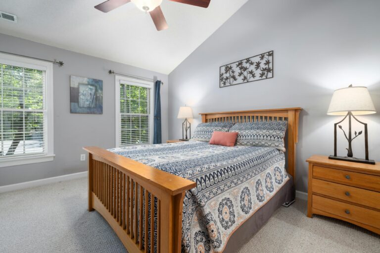 Bright guest bedroom with large bed, natural light, and clean layout for comfortable overnight stays