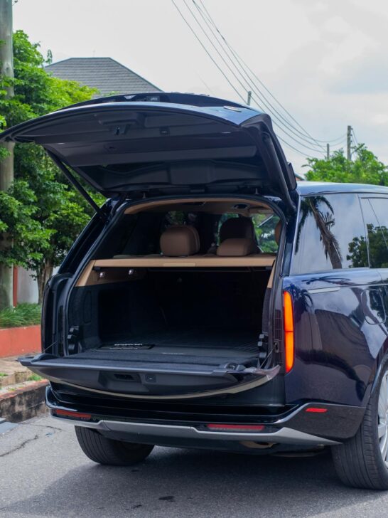 Person using smartphone map for planning neighborhood errands while sitting in car