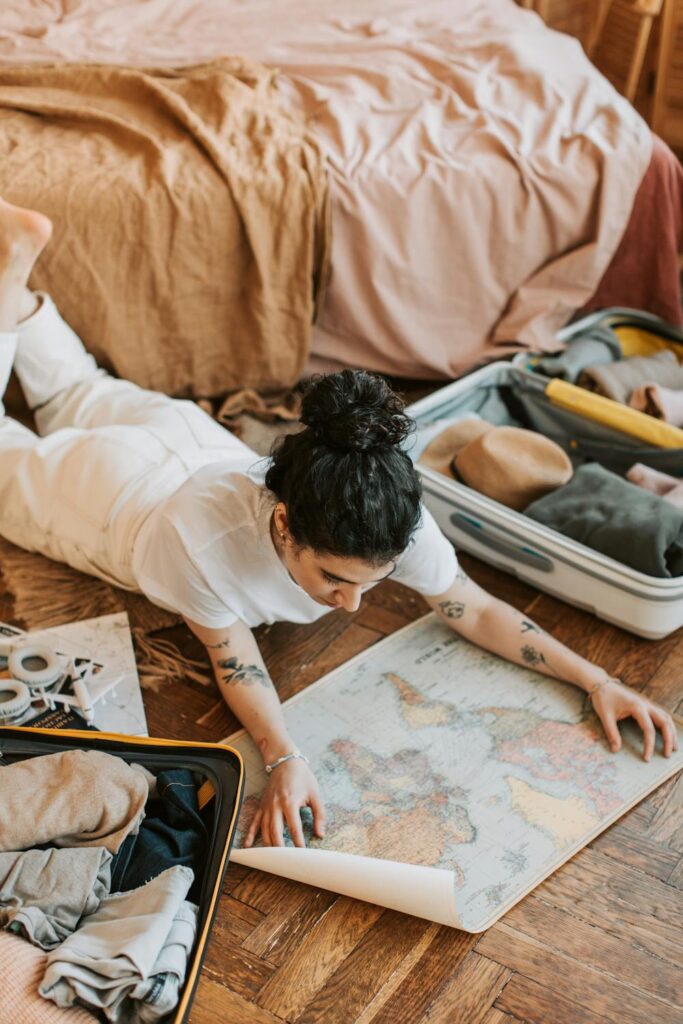 Period travel tips while packing for a trip with suitcase, clothes, and travel essentials spread out
