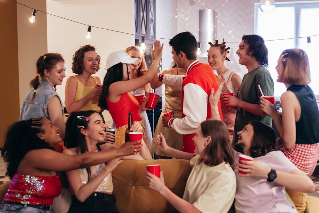 Group of friends celebrating indoors with drinks, laughter, and a lively party vibe