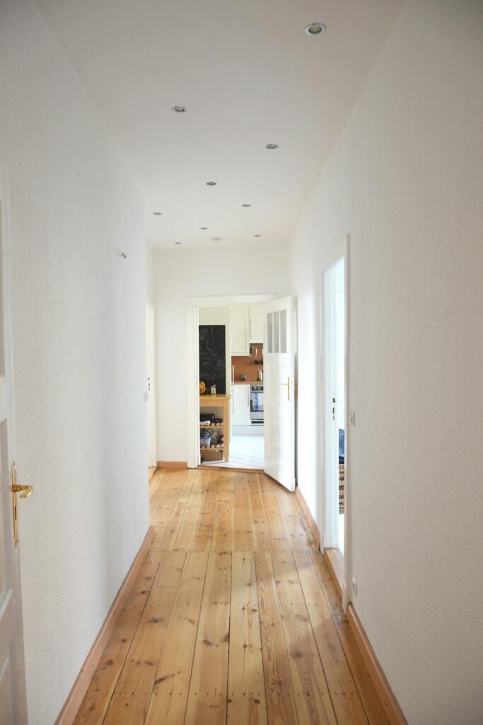 Bright hallway with clear walking space and lighting to improve home safety for seniors