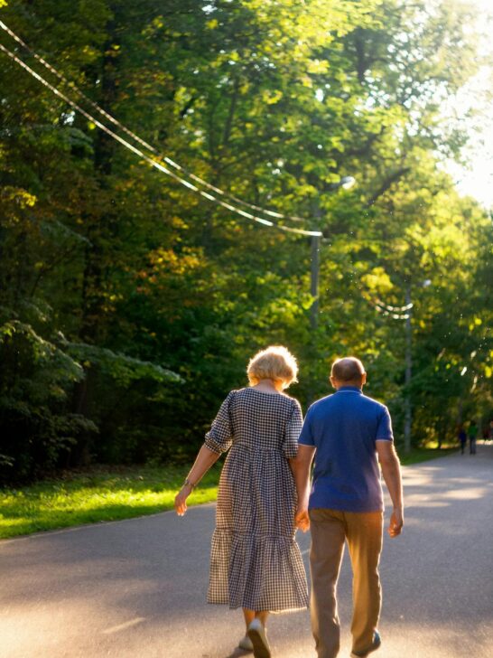 Older couple walking together outdoors in a peaceful setting promoting independence and well-being