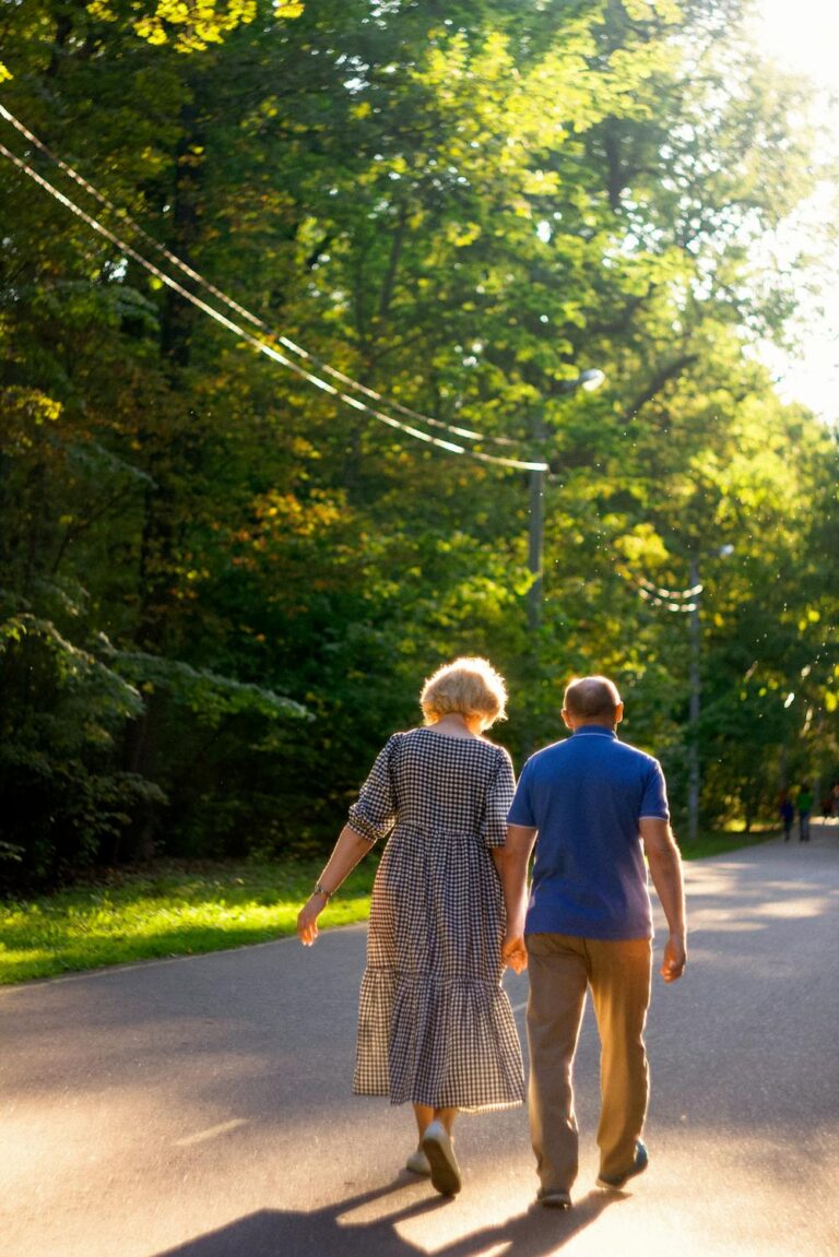 Older couple walking together outdoors in a peaceful setting promoting independence and well-being