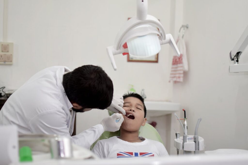 Dentist looking at a child's mouth for wisdom teeth