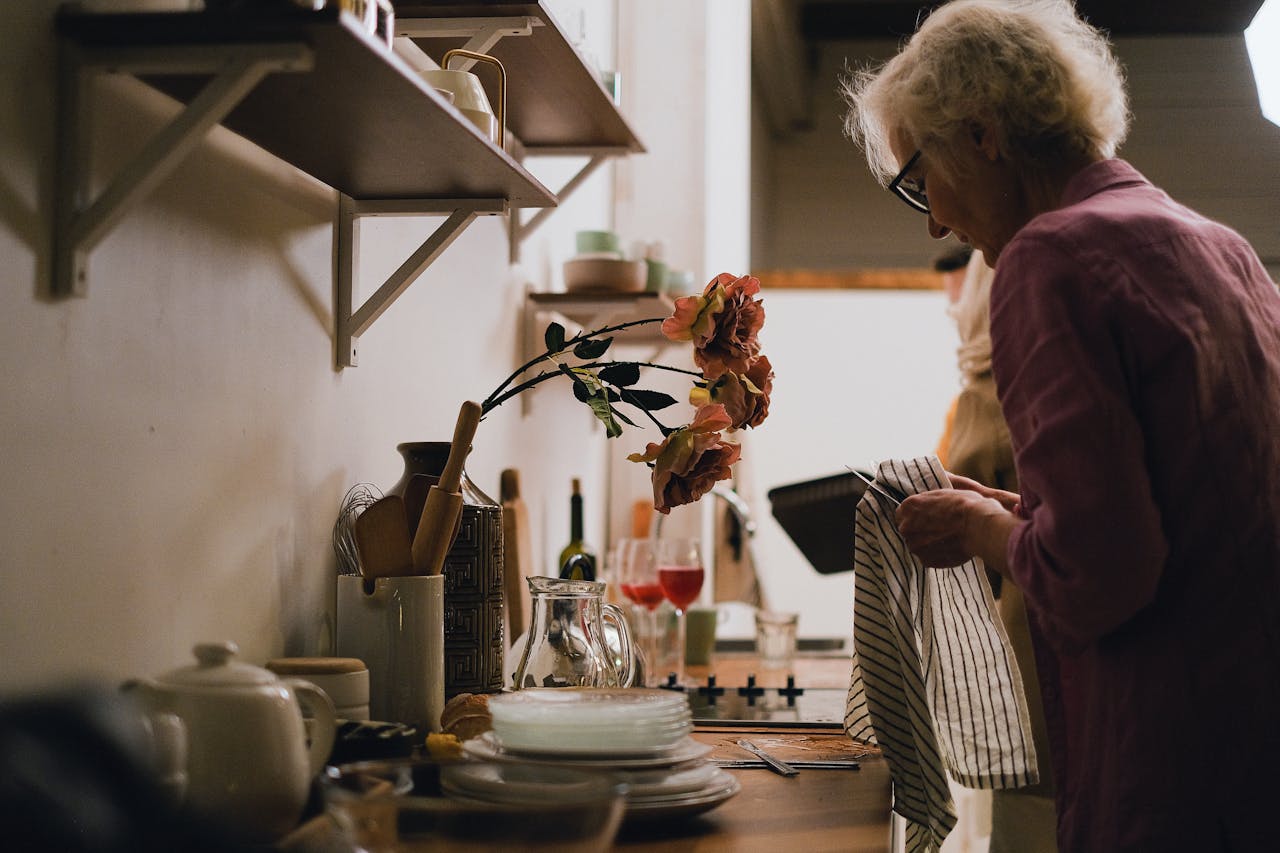 Senior woman completing daily tasks at home showing independent living tips for seniors