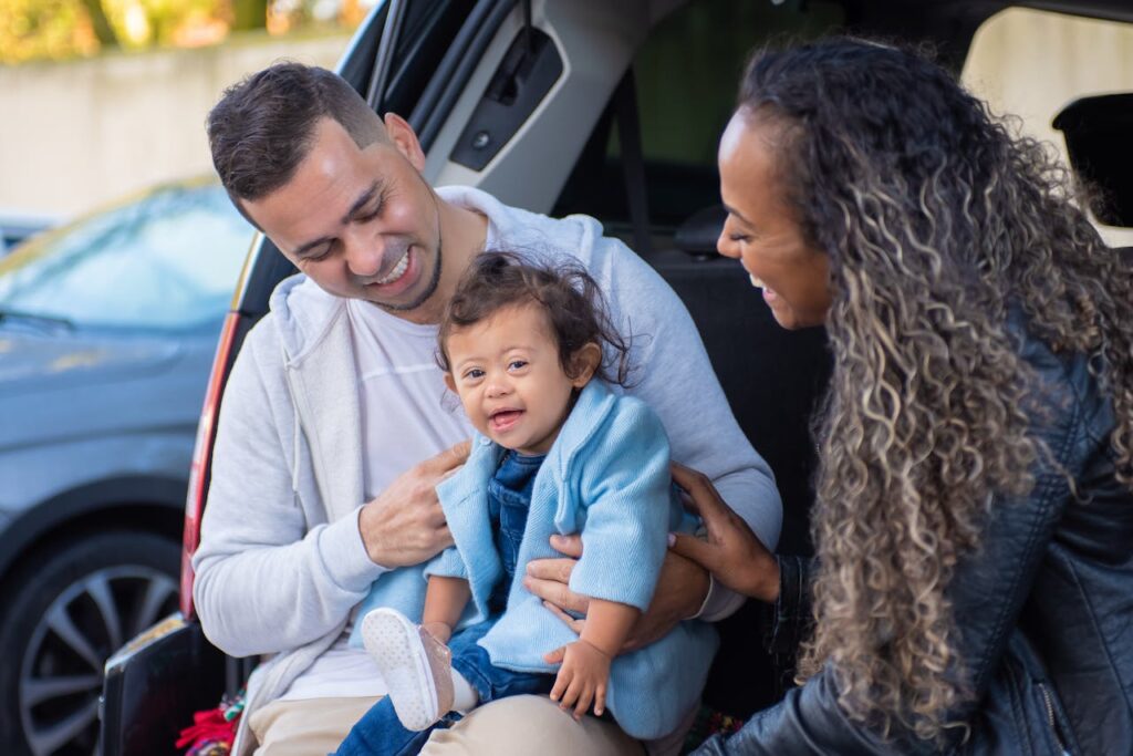 Parents helping a smiling toddler out of an SUV while highlighting family-friendly vehicle features designed for comfort and safety