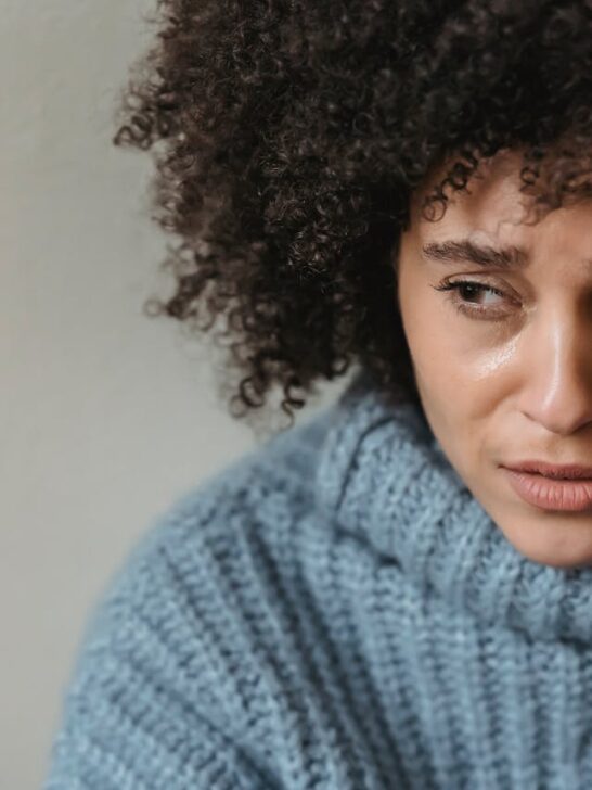 Woman looking stressed and fatigued, showing signs of burnout and mental exhaustion