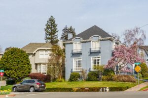 Well-maintained suburban homes with trimmed lawns, flowering trees, and attractive landscaping that enhance curb appeal and property value.