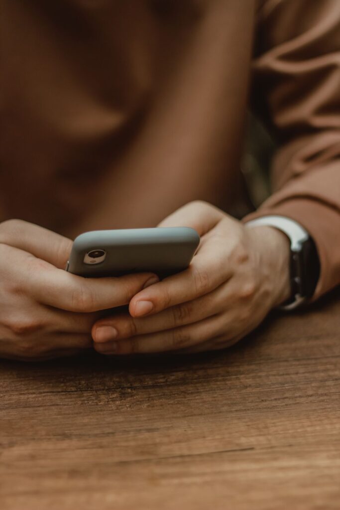 Person using a smartphone to make money on your phone through apps and online opportunities