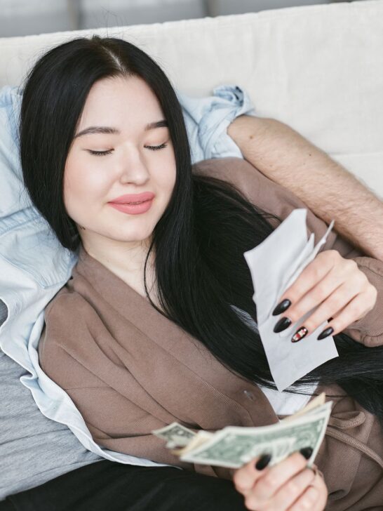 Woman reviewing earnings from side hustles and money-making apps at home