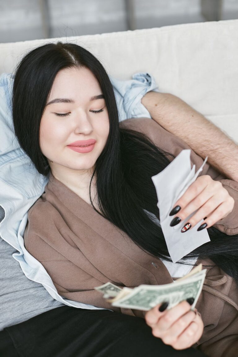 Woman reviewing earnings from side hustles and money-making apps at home