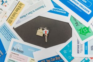 House keys resting on mortgage paperwork and home buying documents