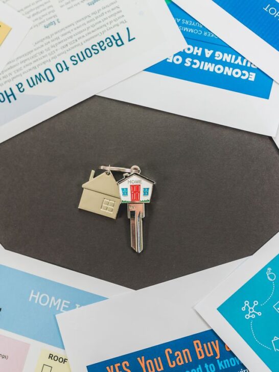 House keys resting on mortgage paperwork and home buying documents