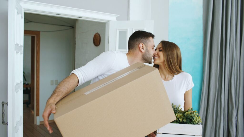 Couple moving into their new home together, celebrating one of life's biggest relationship milestones.