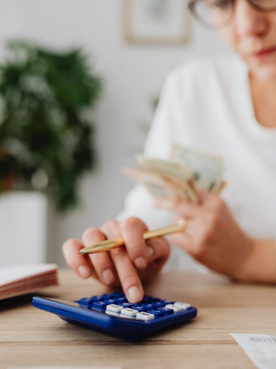Woman calculating expenses to identify areas where people overspend