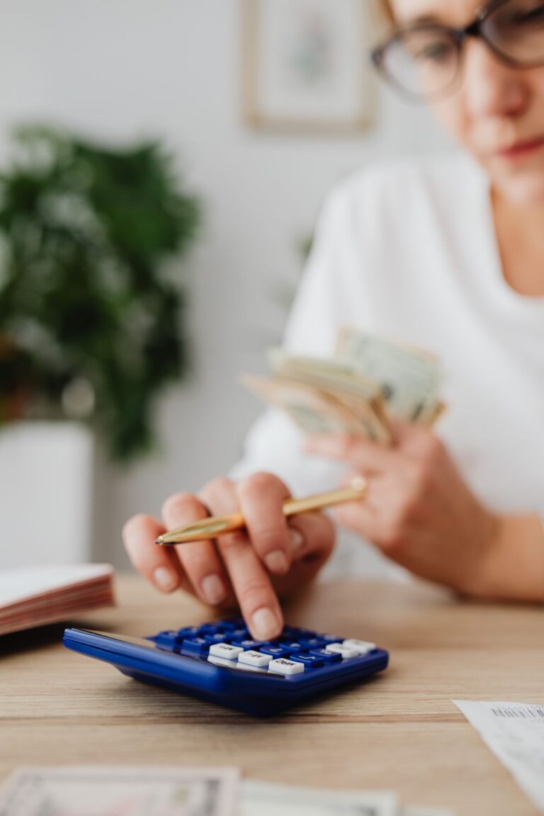 Woman calculating expenses to identify areas where people overspend