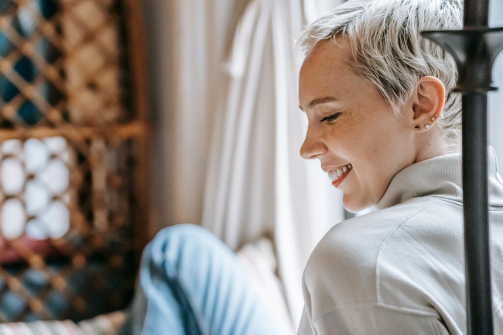 Smiling mother showing confidence and self-care, highlighting the importance of dental care for moms and maintaining a healthy smile.