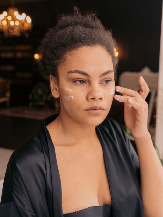 Person applying skincare cream to the face as part of a daily routine designed to improve hydration, elasticity, and skin firmness over time.