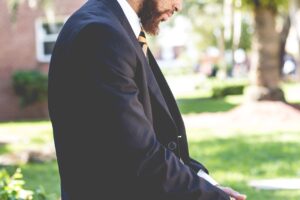 Man in a suit demonstrating how to choose a men's fragrance that matches his personality.