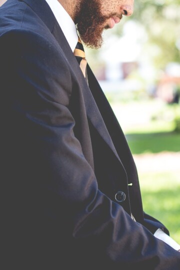 Man in a suit demonstrating how to choose a men's fragrance that matches his personality.