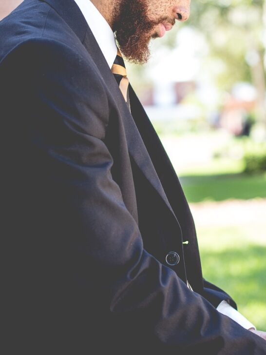 Man in a suit demonstrating how to choose a men's fragrance that matches his personality.
