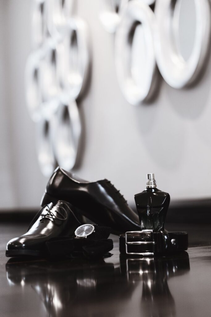 Men's fragrance with dress shoes, watch, and accessories for a guide on how to find a signature fragrance.