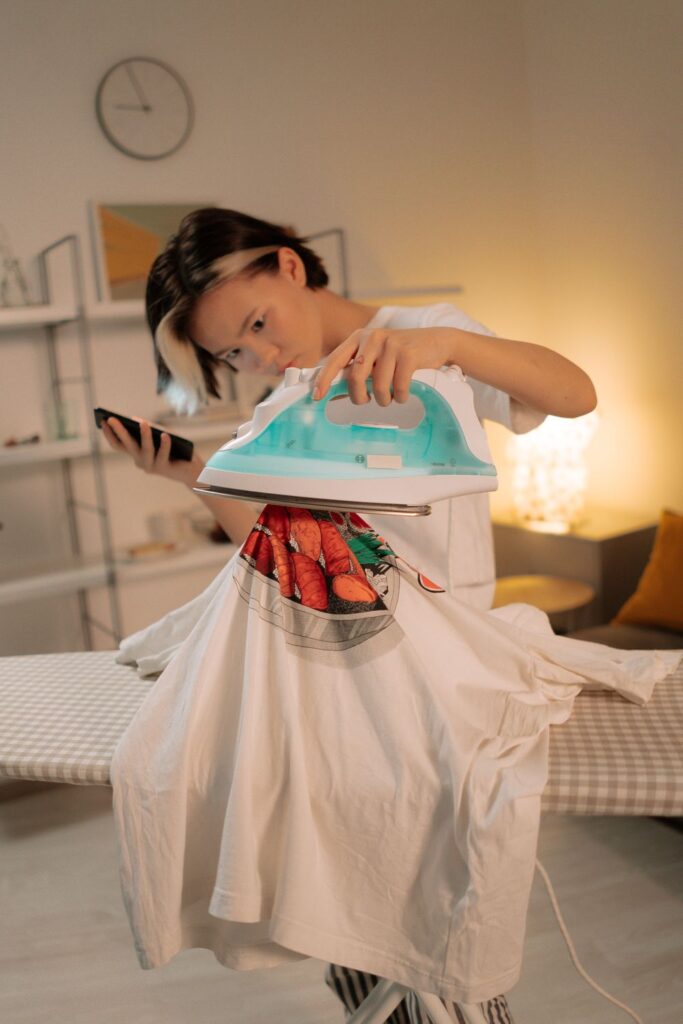 Person applying a custom design with a heat press, creating personalized crossbody bags and other handmade accessories