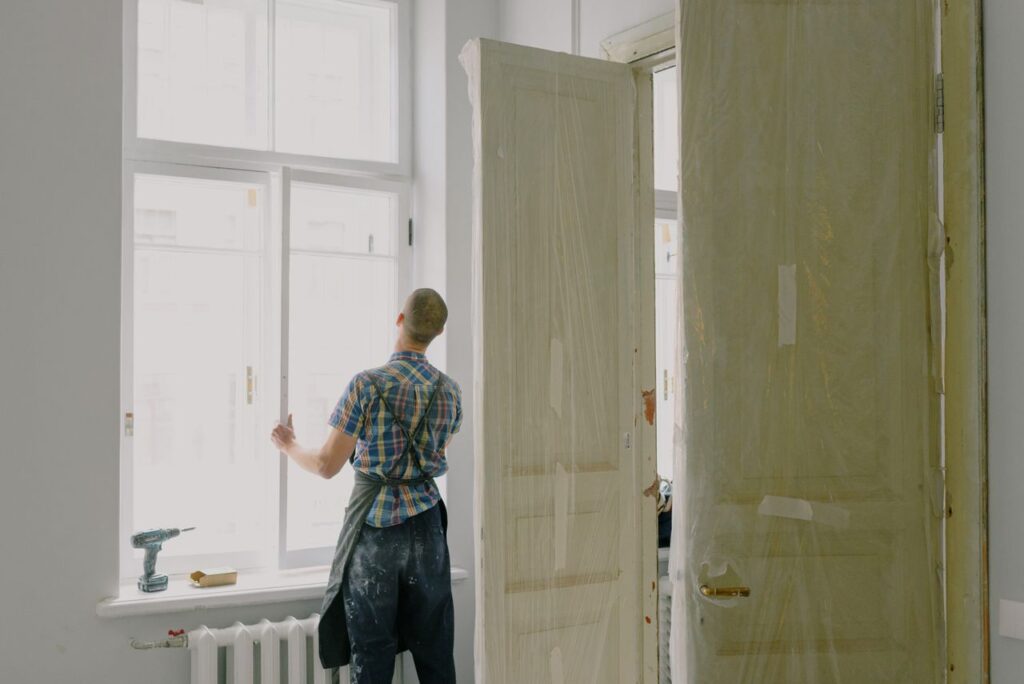 Person working on home repairs and renovations, highlighting the time and effort often involved in preparing a property for sale.