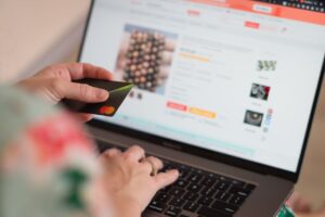 Laptop displaying an online shopping page with colorful shopping bags, representing how to buy home products online with confidence.