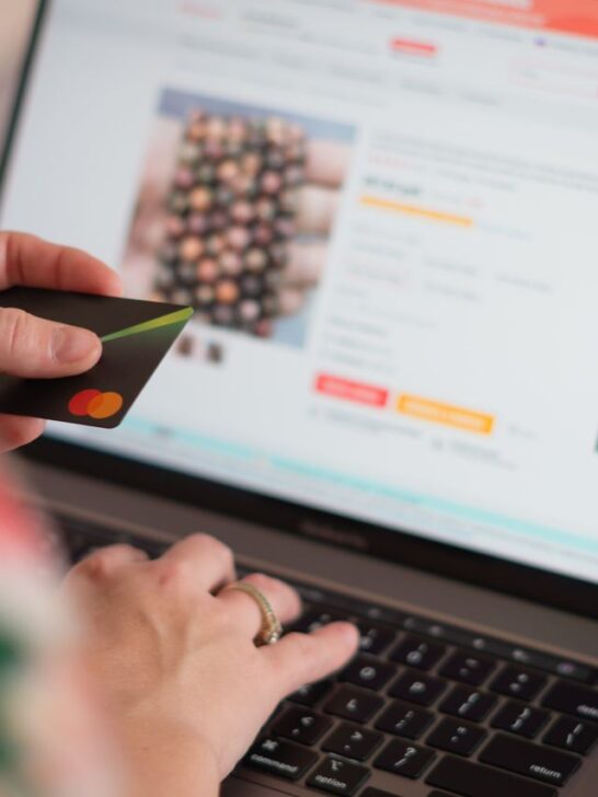 Laptop displaying an online shopping page with colorful shopping bags, representing how to buy home products online with confidence.