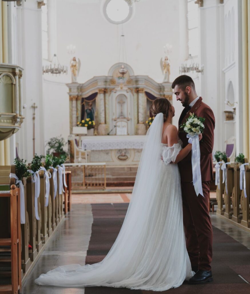 Bride and groom standing together at the altar during their wedding ceremony in a church.