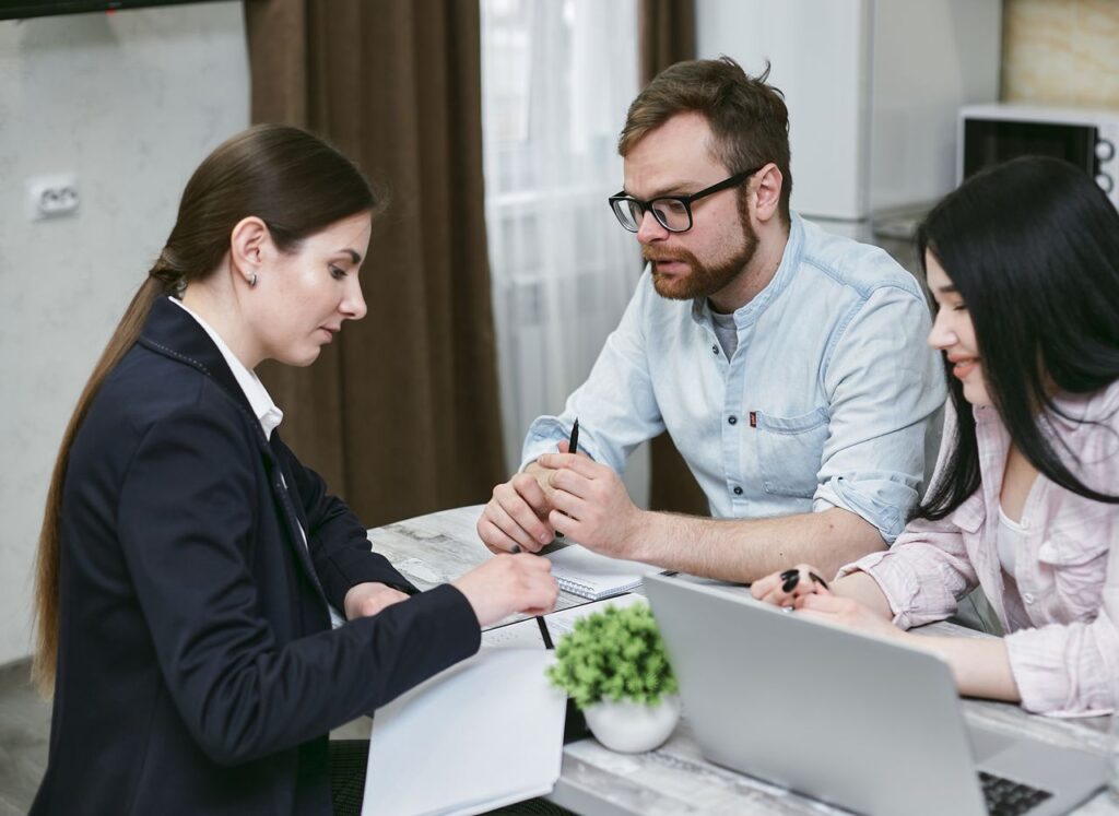 Couple meeting with an insurance advisor to discuss life insurance coverage options and determine the right policy for their family's needs.