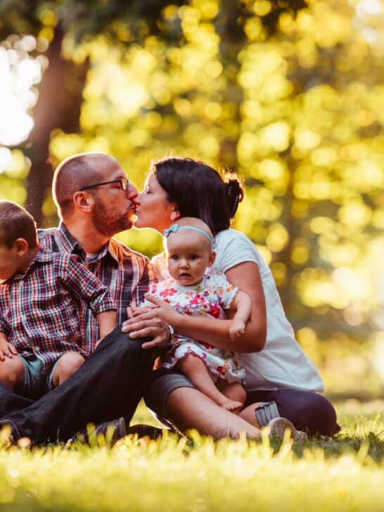 How much life insurance do I need? A family with two young children spending time together outdoors while planning for their financial future.