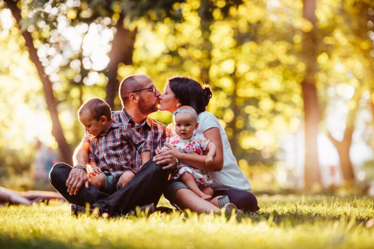 How much life insurance do I need? A family with two young children spending time together outdoors while planning for their financial future.