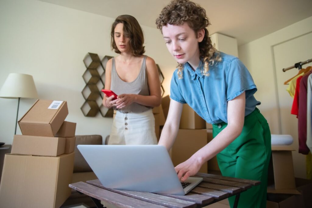 Small business owners preparing orders while learning how to sell children's jewelry online and grow an ecommerce business.