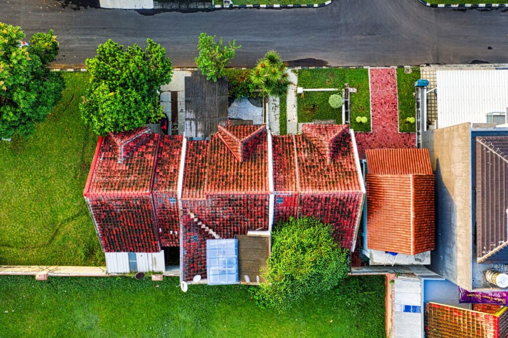 Aerial view of homes showcasing quality building materials with durable red tile roofs and well-maintained residential construction.