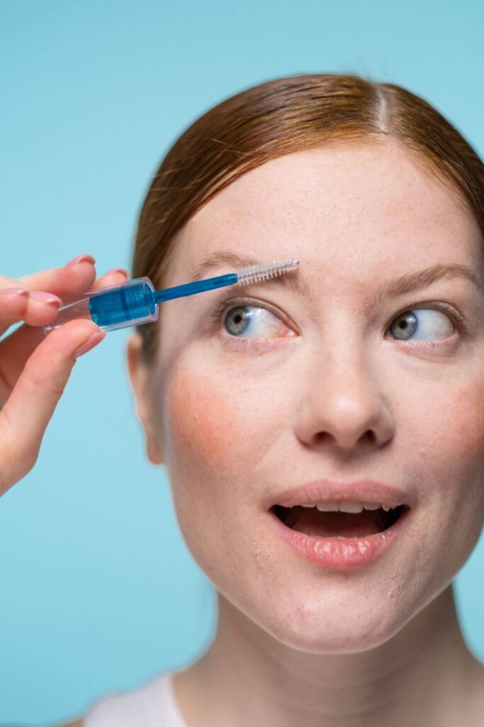 Woman applying eyebrow serum to her brows, illustrating how do eyebrow serums work for fuller, healthier-looking eyebrows.