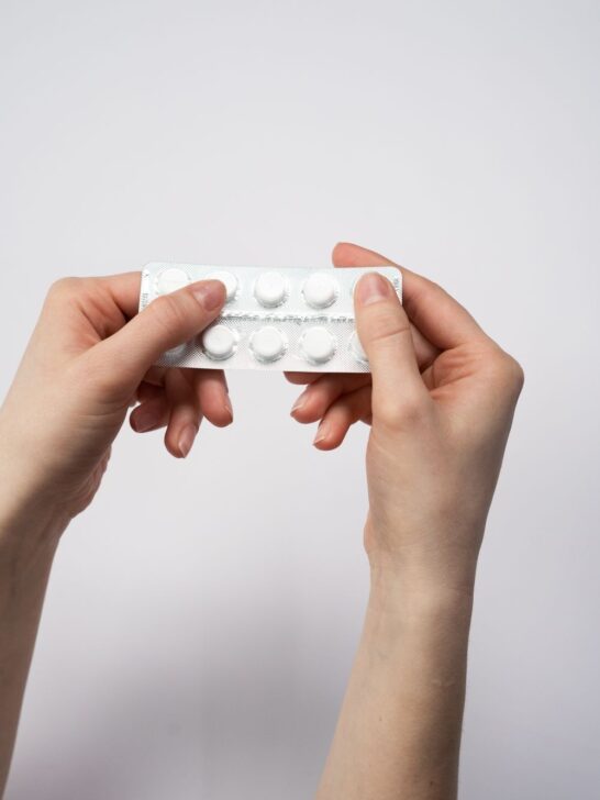 Hands holding a birth control pill pack illustrating PCOS and birth control.