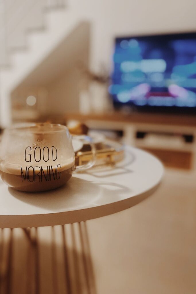 Cozy morning coffee ritual featuring a Good Morning mug on a table in a warm, relaxing living room.