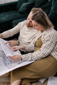 Couple reviewing floor plans while planning their new construction home