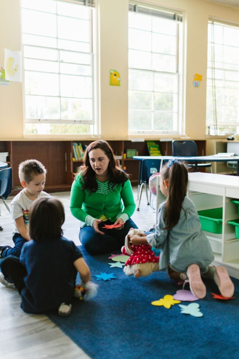 Teacher leading a small group activity to encourage social skills and emotional development in young children.