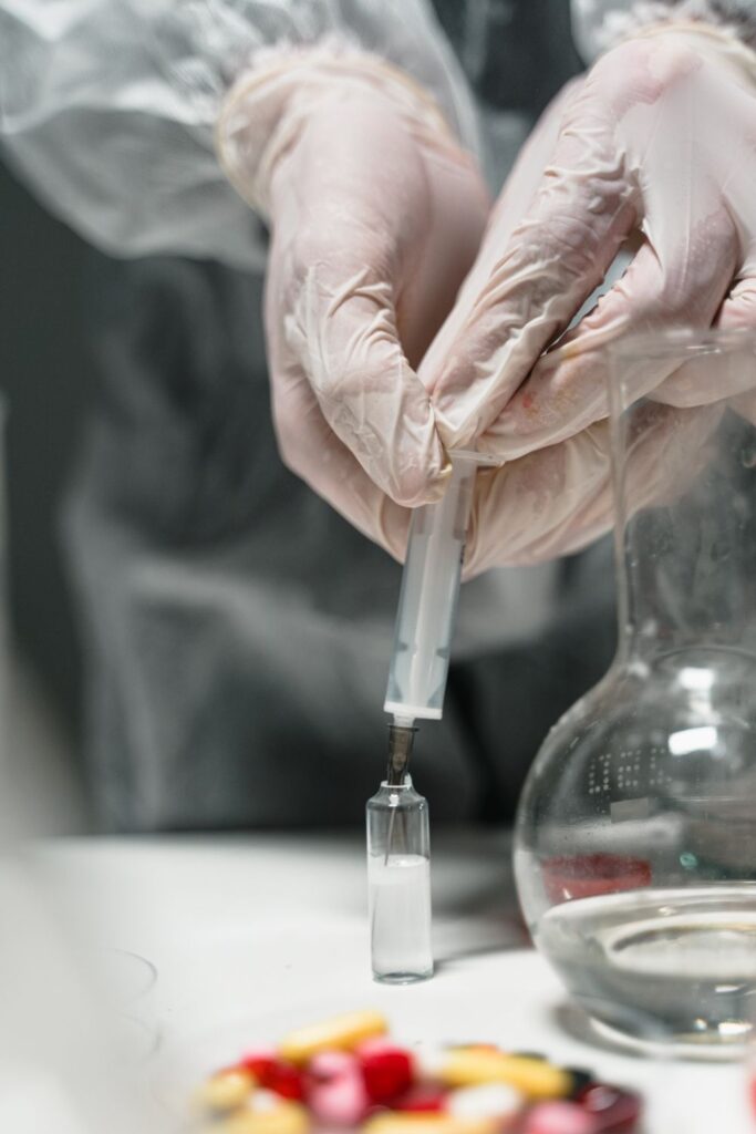 Workplace drug testing sample being prepared by a laboratory technician wearing protective gloves.