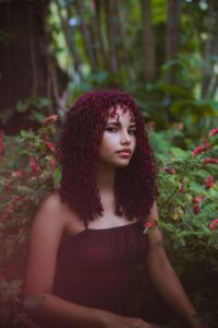 Woman with long curly DIY burgundy hair