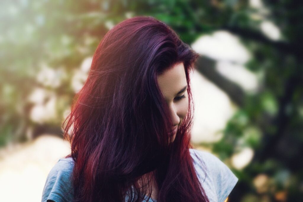 Woman with long, dark burgundy hair