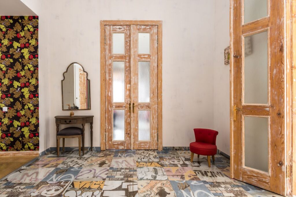 Classic patterns in modern interiors with botanical prints, geometric cushions, and contemporary furnishings