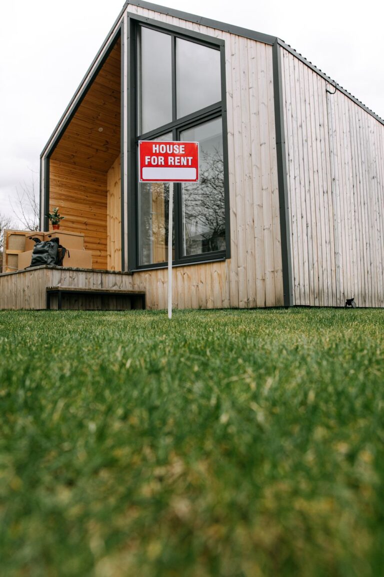 Rental house with a for-rent sign representing an emergency maintenance budget for rental property expenses