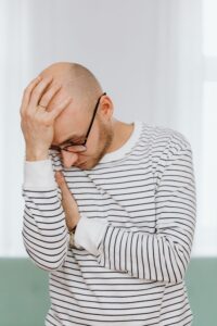 Man experiencing a headache, one of several everyday health issues that are easy to overlook