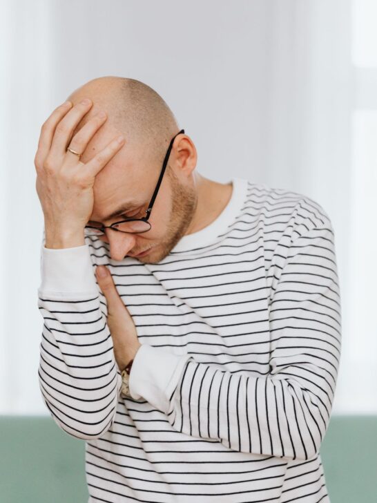 Man experiencing a headache, one of several everyday health issues that are easy to overlook