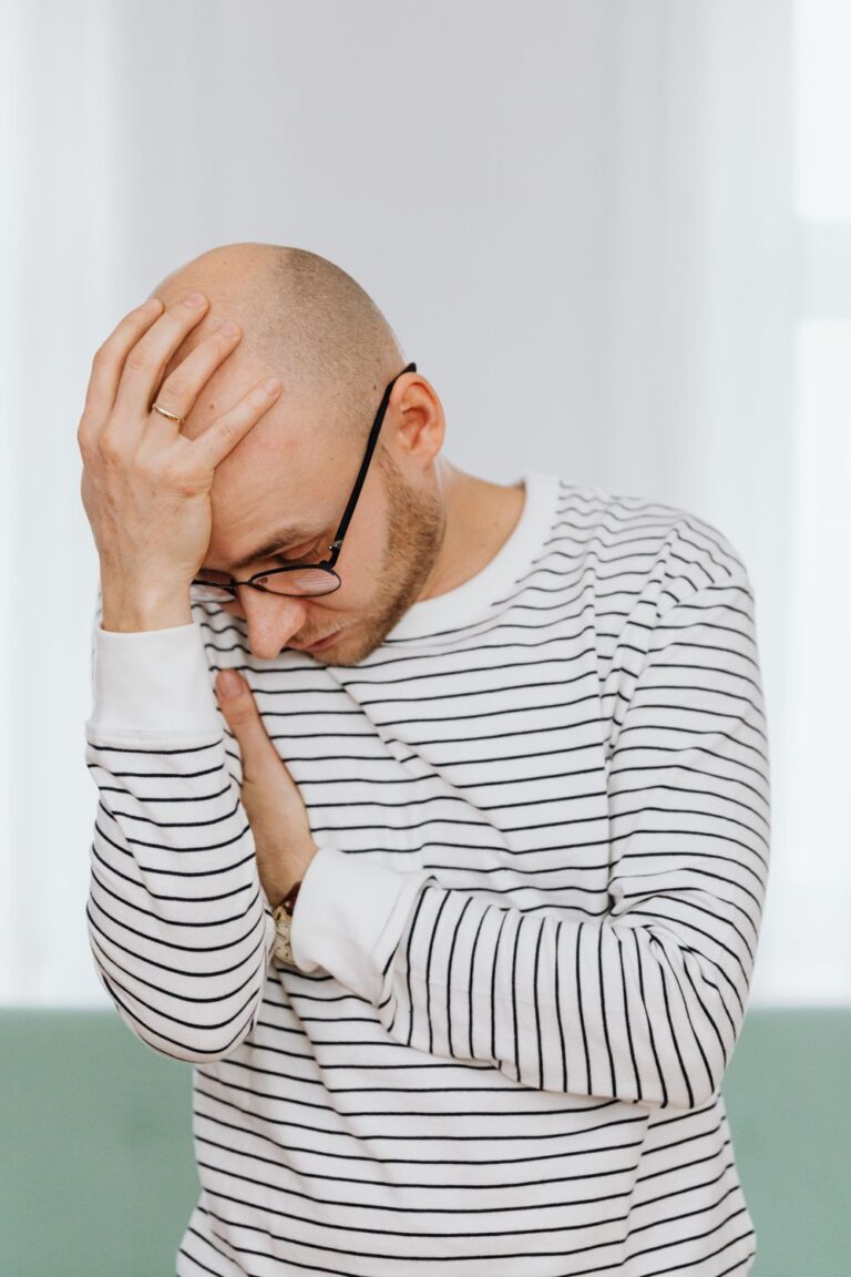 Man experiencing a headache, one of several everyday health issues that are easy to overlook
